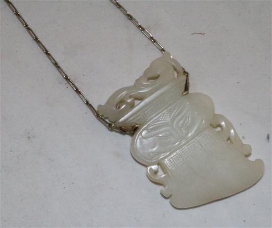 A Chinese archaistic white jade pendant, 19th / 20th century, (26cm drop), jade 6.7cm